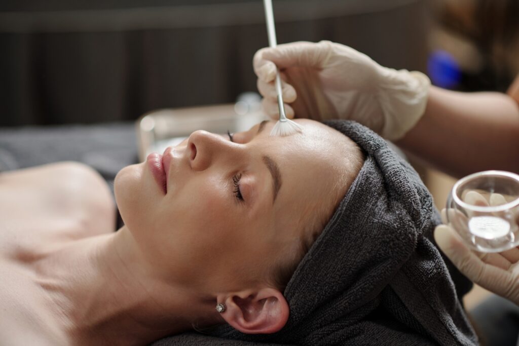 Esthetician,Applying,Glycolic,Acid,Peel,On,Face,Of,Young,Woman Chemical Peels Sugar Land TX