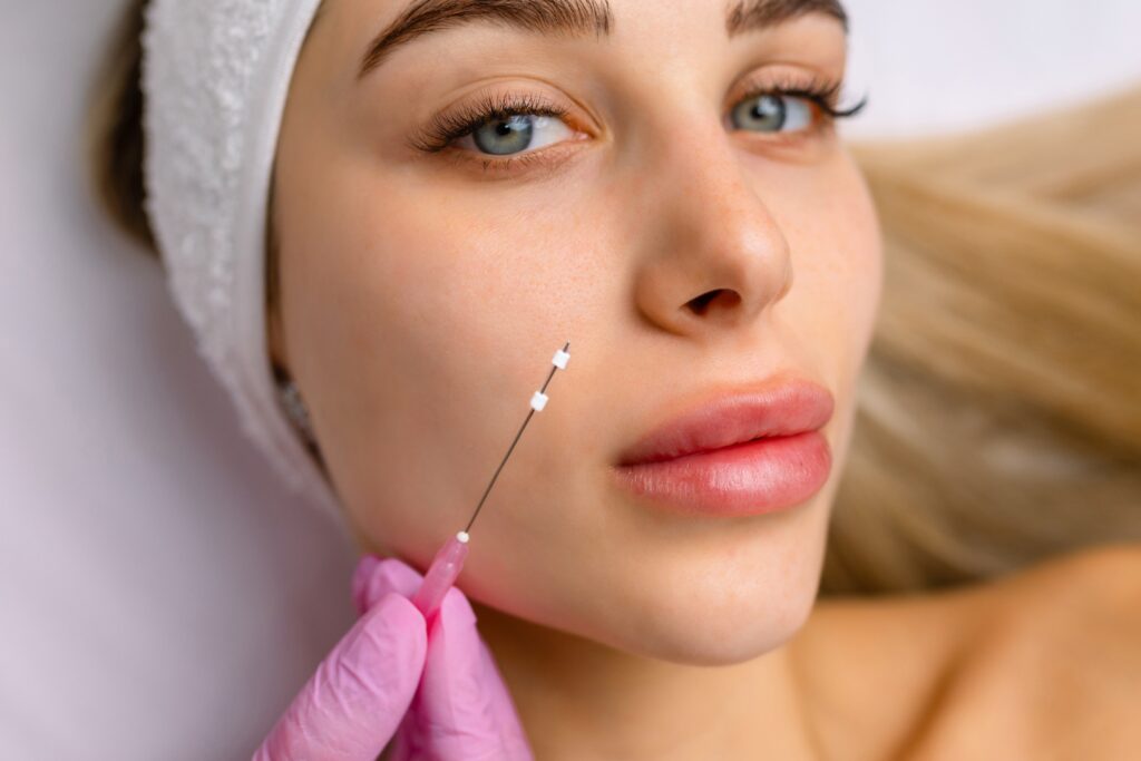 Cosmetologist preparing for PDO thread lift face lifting procedure, selecting appropriate suture threads for non-surgical facial rejuvenation