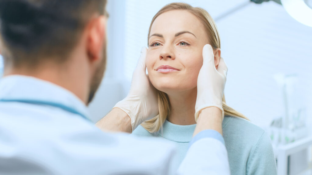 Woman preparing to receive Sculptra injection for facial volume restoration and collagen stimulation.