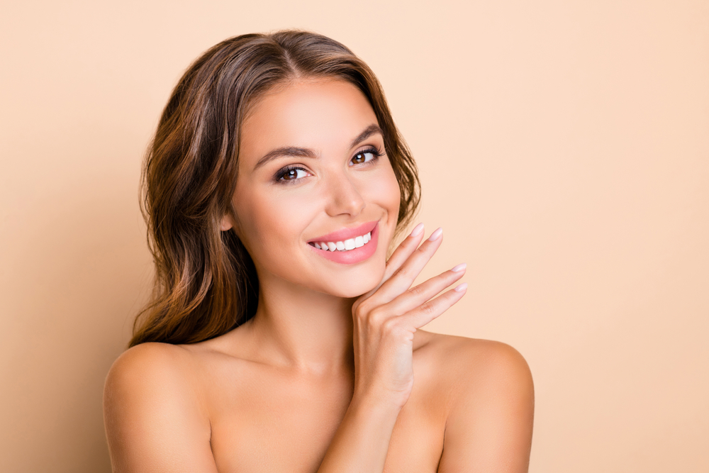 Woman smiling with smooth skin after facial treatment for crepey skin