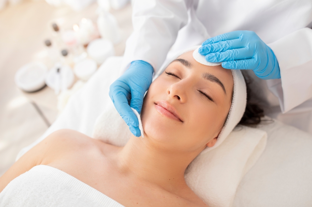 Patient receiving a relaxing facial for skin rejuvenation treatment.